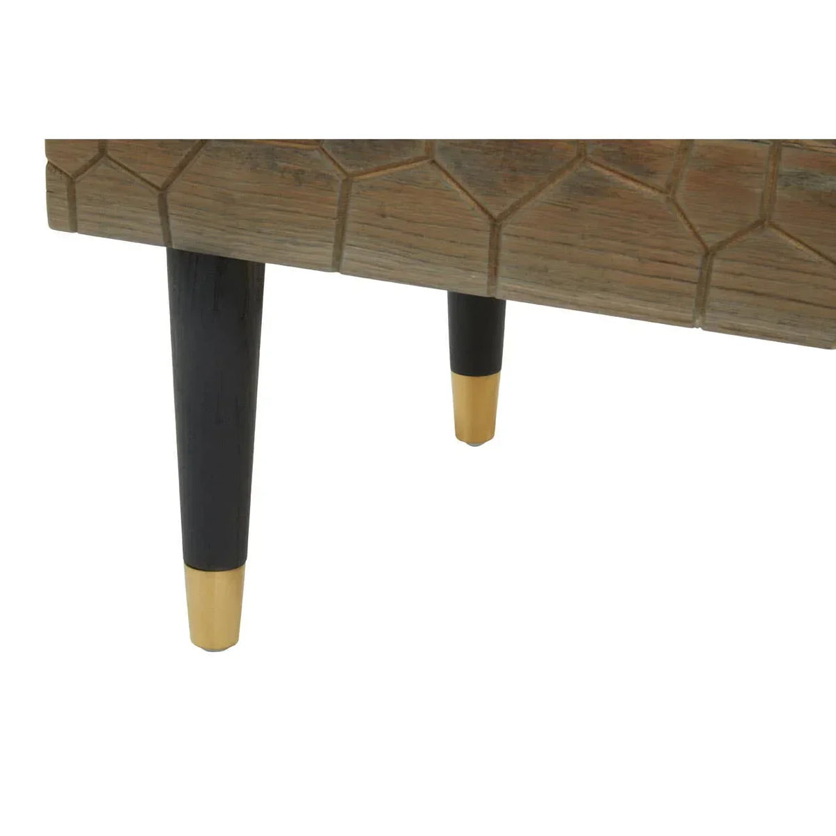 Wooden furniture leg detail with black tapered legs and gold metal caps