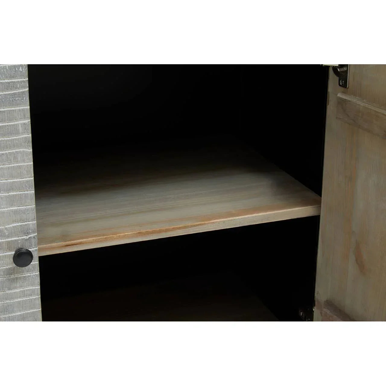 Interior view of wooden cabinet shelf with open door and textured wood grain