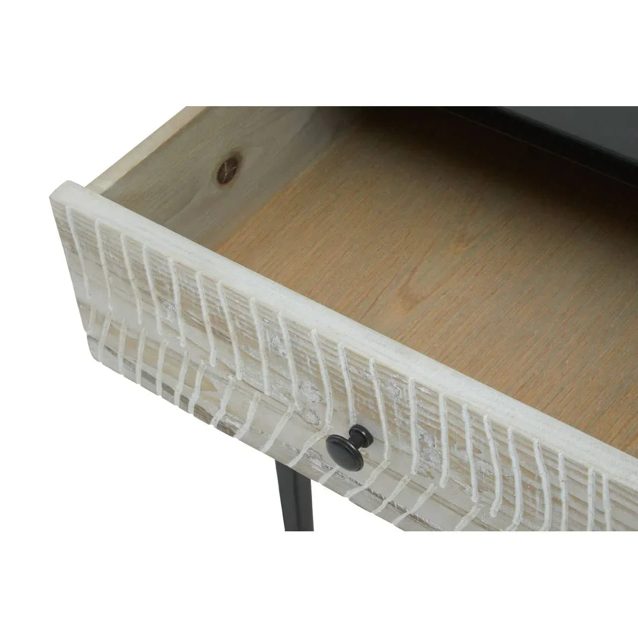 Close up of wooden drawer with carved white front and black metal knob