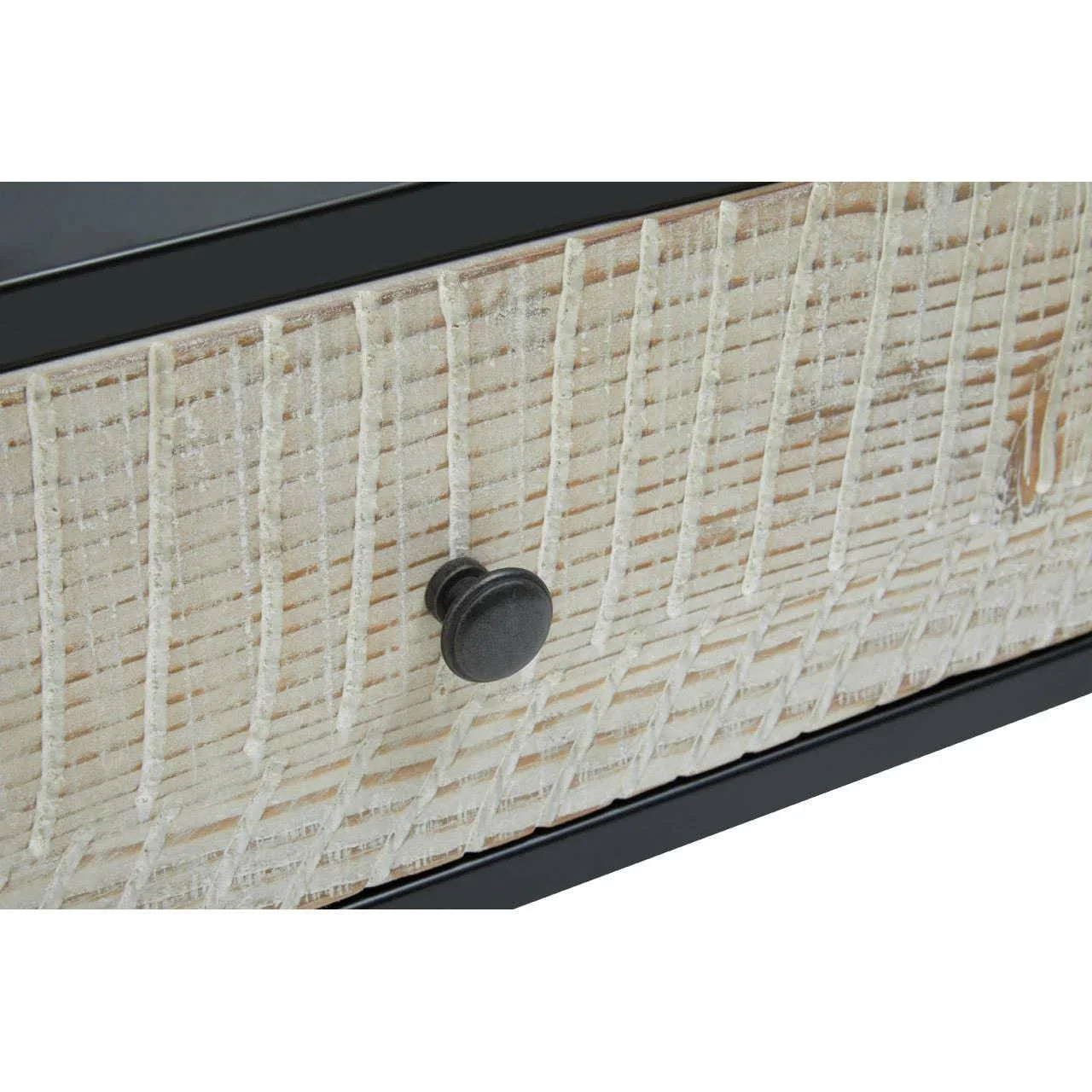 Closeup of wooden drawer front with textured pattern and round metal handle