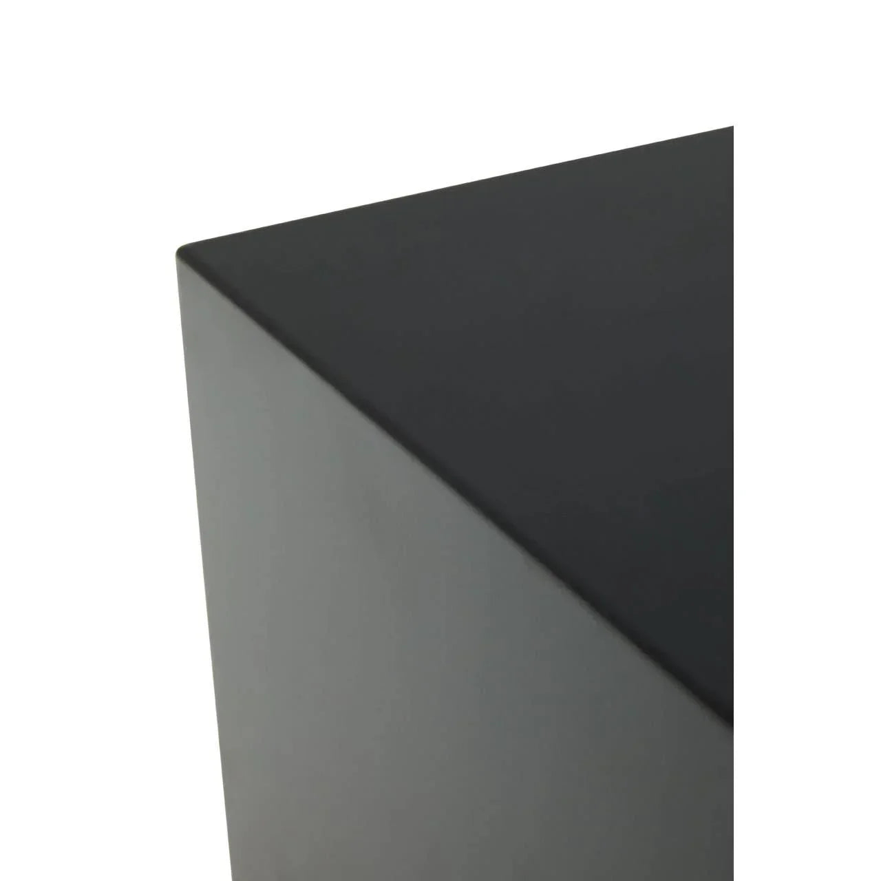Close-up of black table corner with smooth matte finish