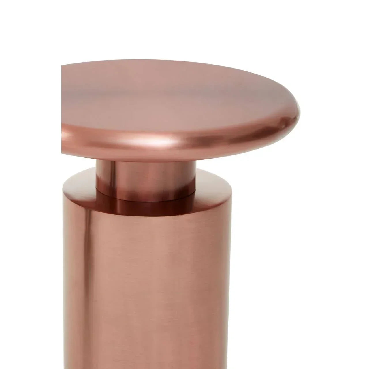 Close-up of metallic copper side table with round top and cylindrical base