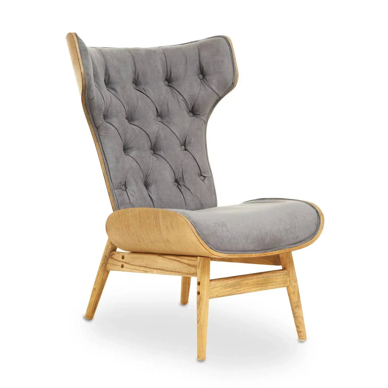 Grey velvet accent chair with buttoned backrest and light wood frame, side angle view