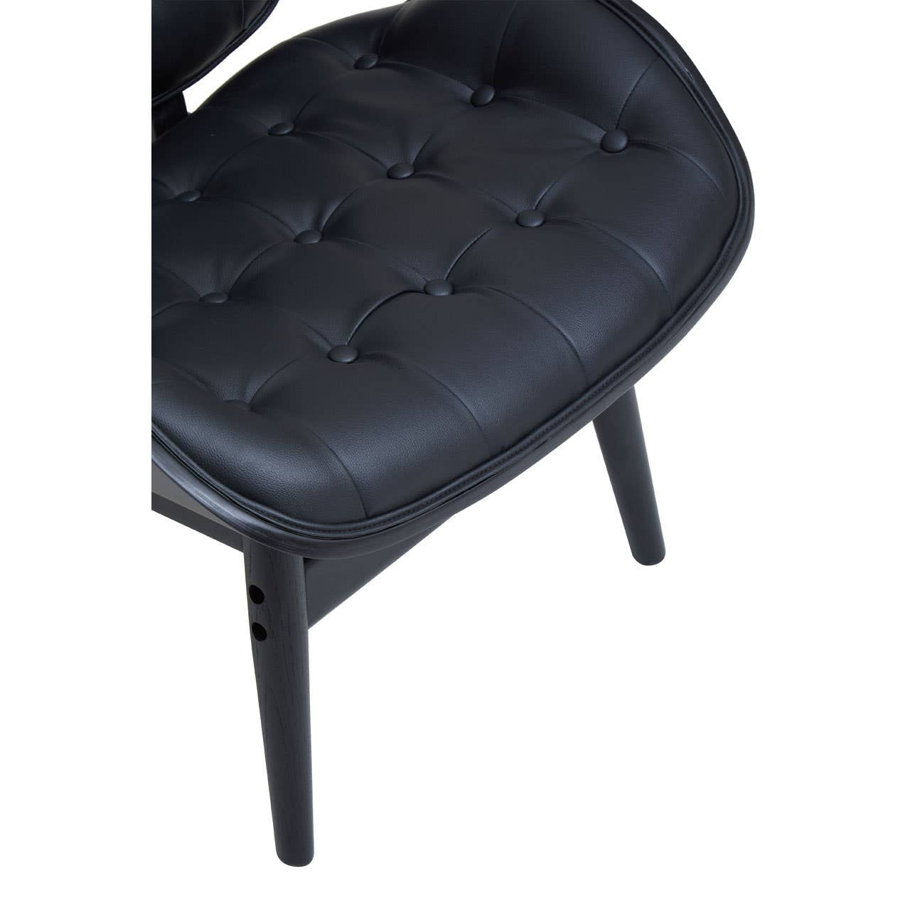 Black leather effect chair featuring a tufted seat with rounded edges and a sleek design. The chair is supported by sturdy black wooden legs, showcasing a modern aesthetic.