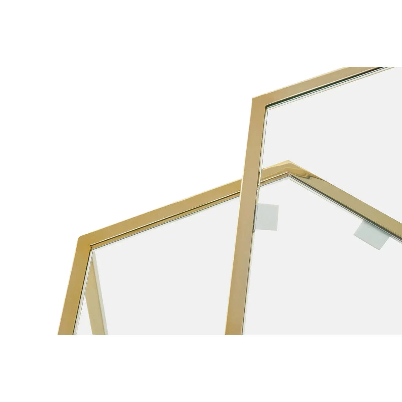 Close-up of gold metal coffee table frame with clear glass top