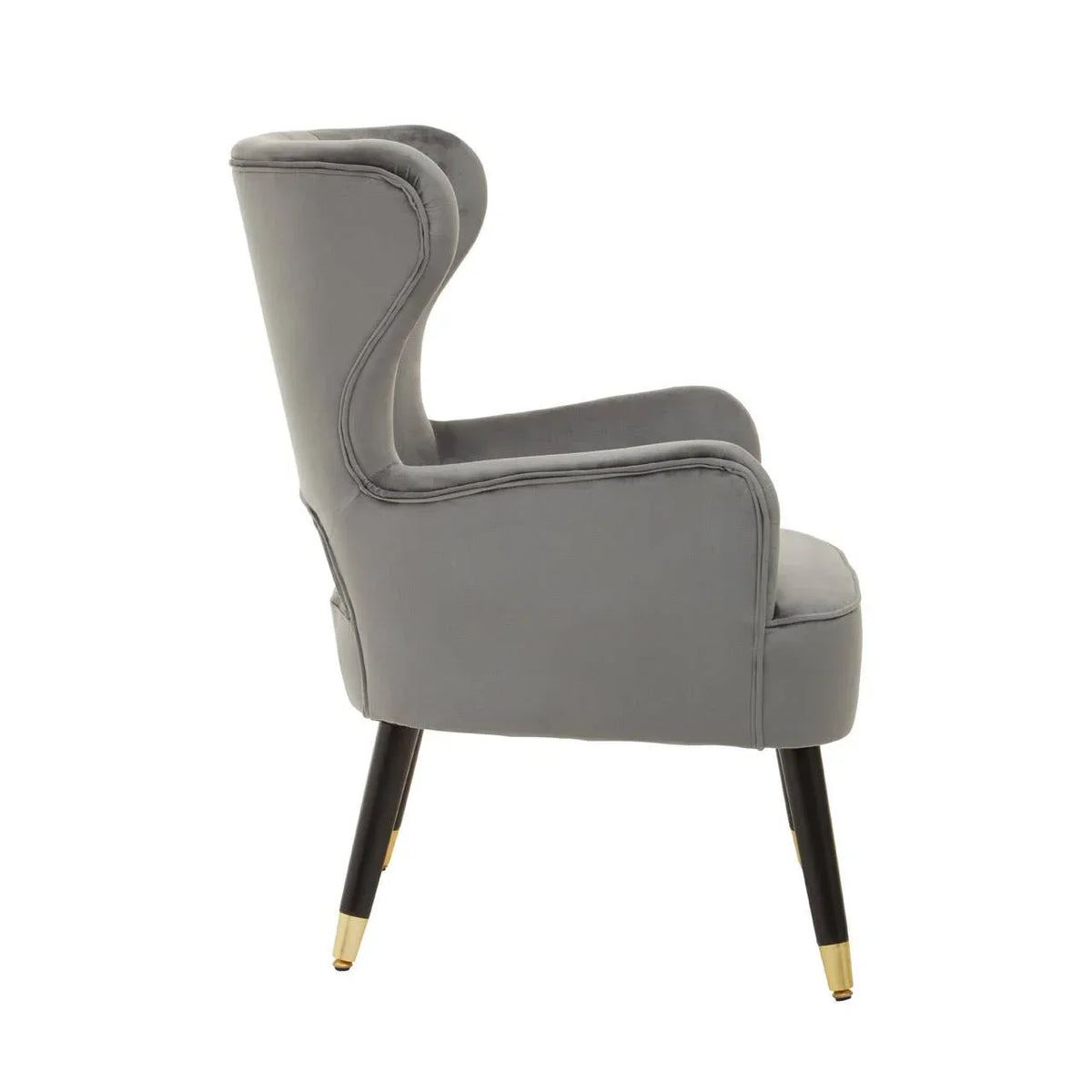 Side view of grey velvet accent chair with black legs and gold metal caps
