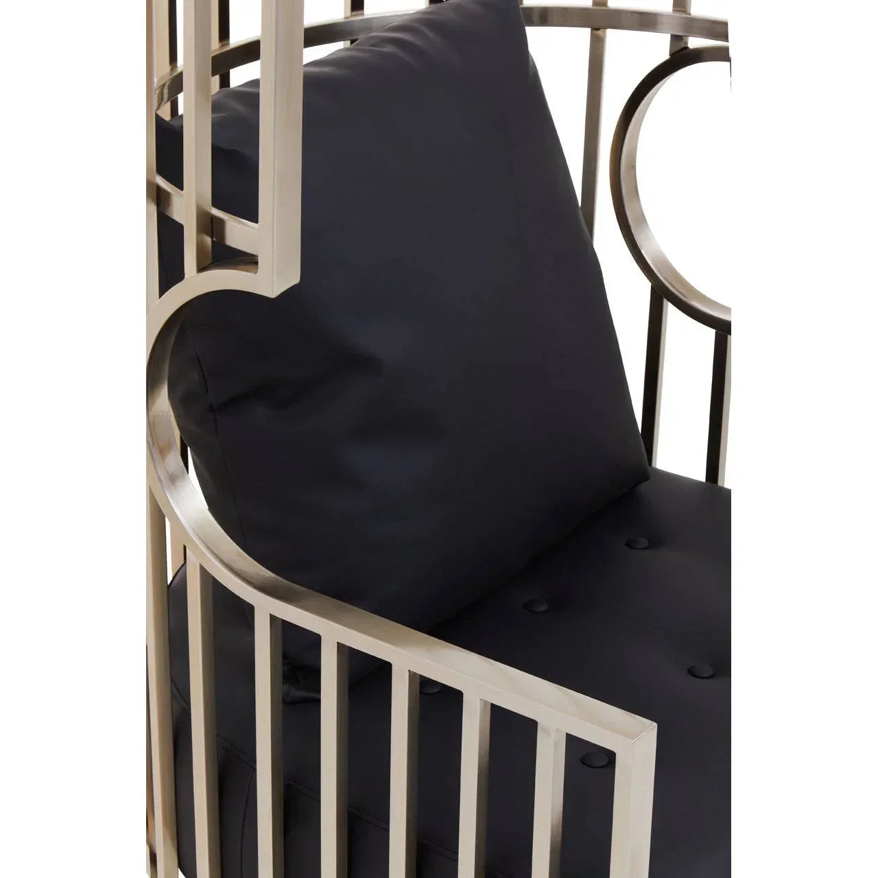Close-up of metal armchair with black cushion and button-tufted seat