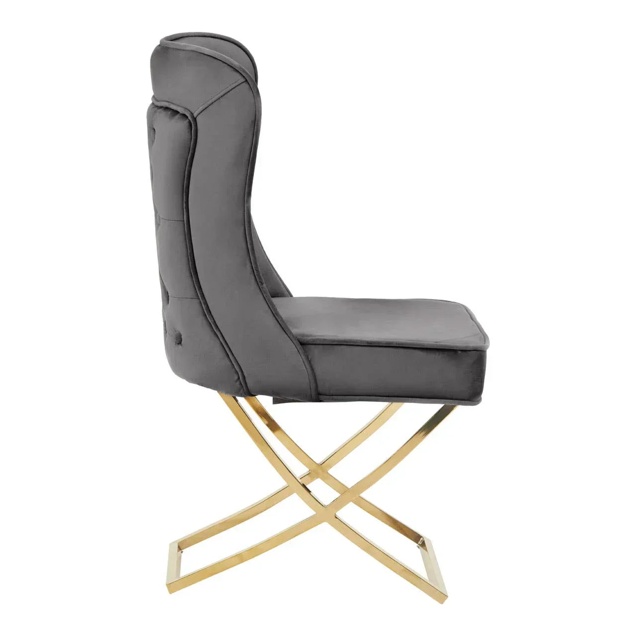 Grey velvet dining chair with gold metal crossed legs, side profile view