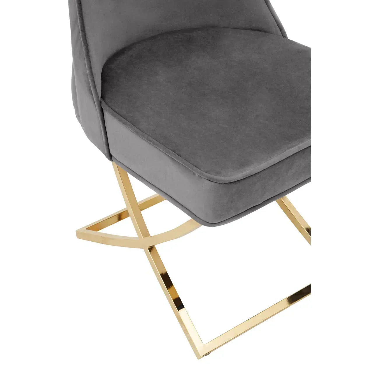 Grey velvet dining chair with gold metal base, close-up of seat and legs