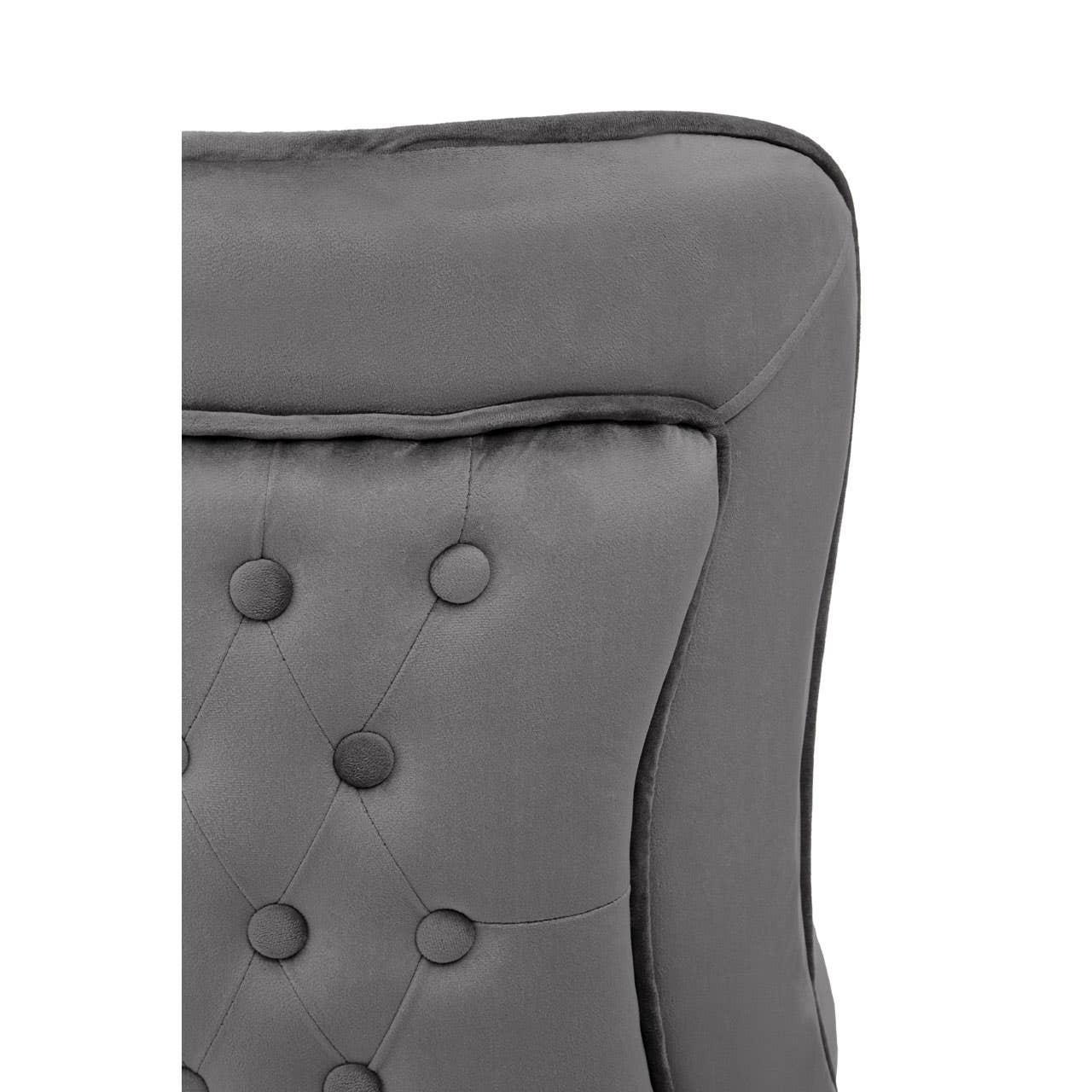 Close-up of grey velvet armchair backrest with button tufted upholstery