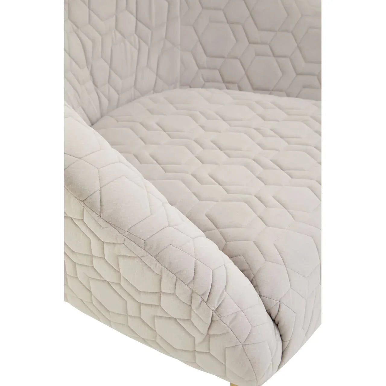 Close view of beige quilted armchair seat with geometric pattern upholstery
