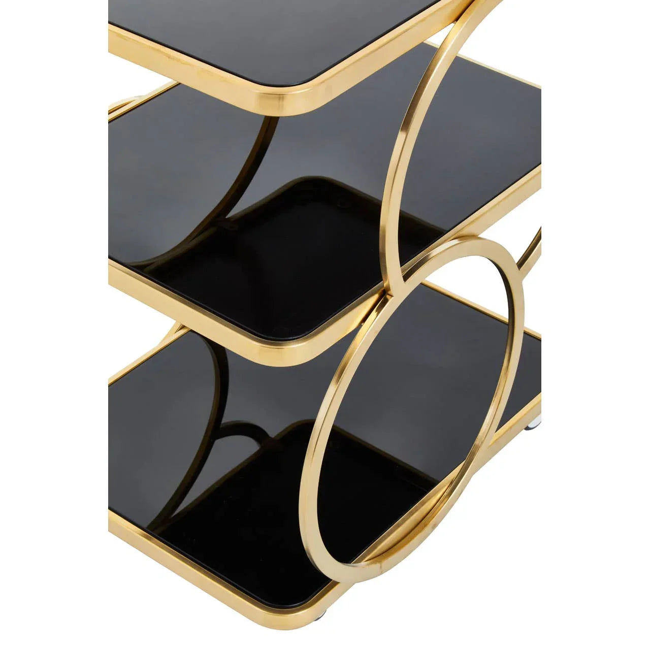Gold metal side table with black glass shelves and circular frame detail