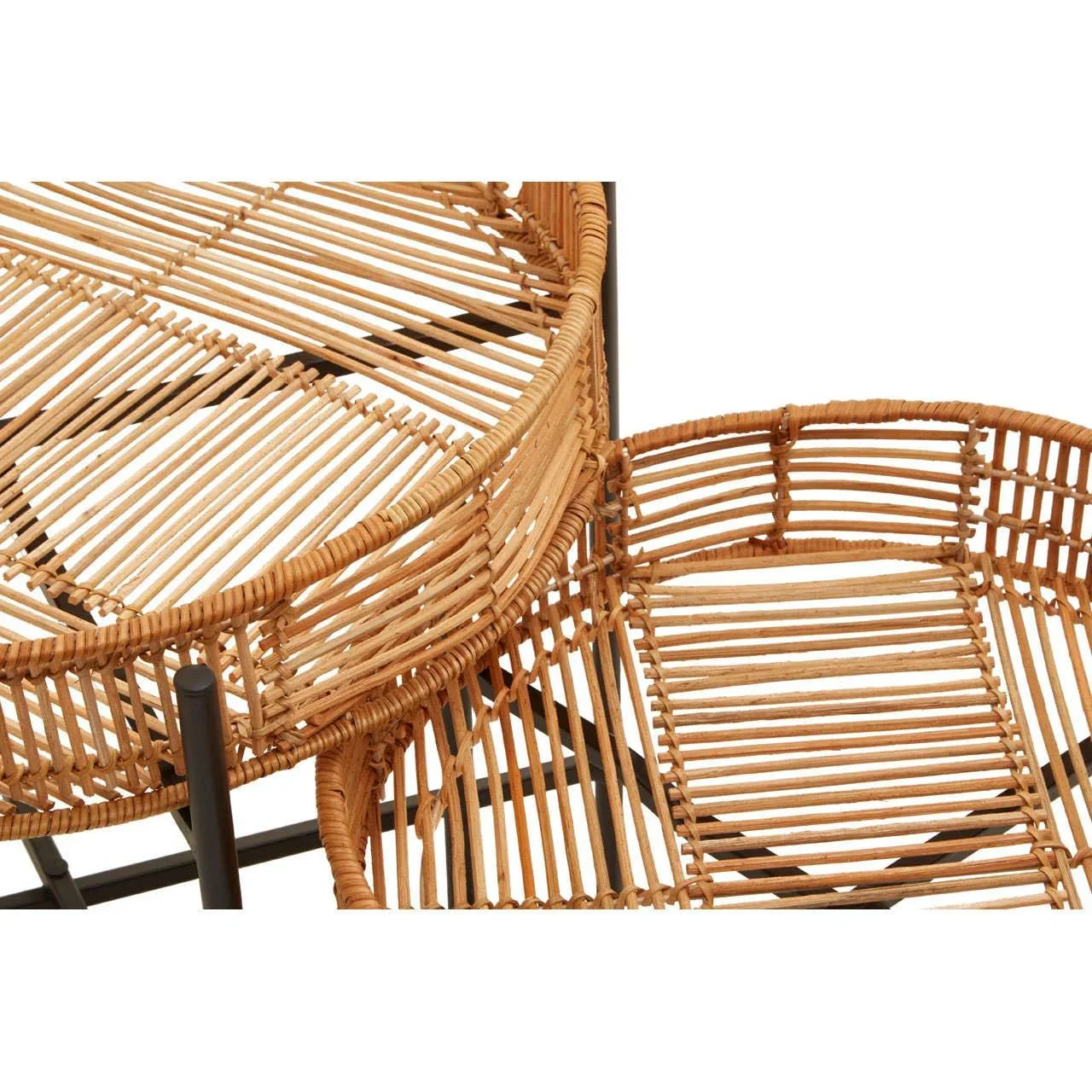 Rattan nesting tables with woven detail and black metal frames, partial top view