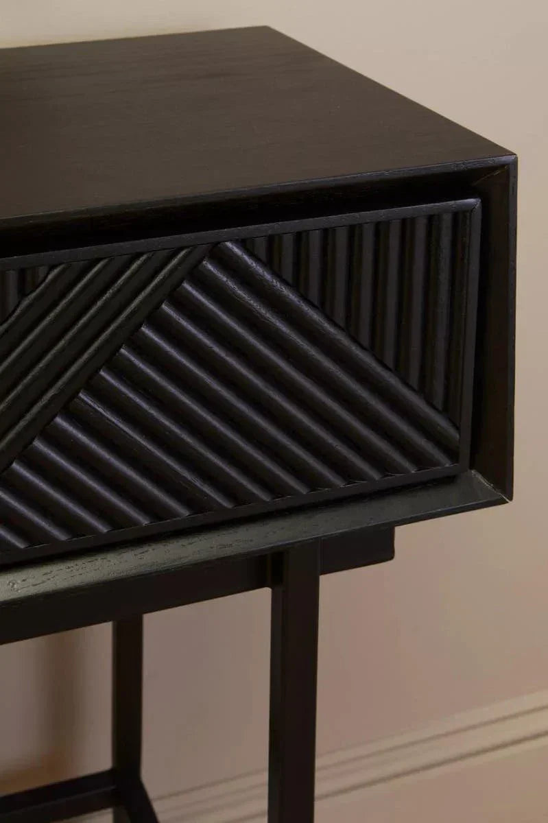 Black wooden bedside table with textured diagonal drawer front detail