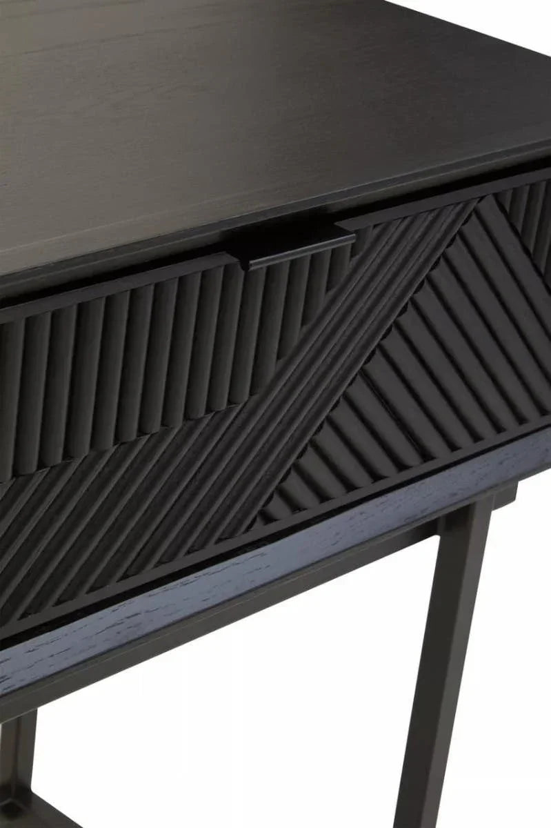 Black wooden console table with textured chevron drawer front and slim metal legs