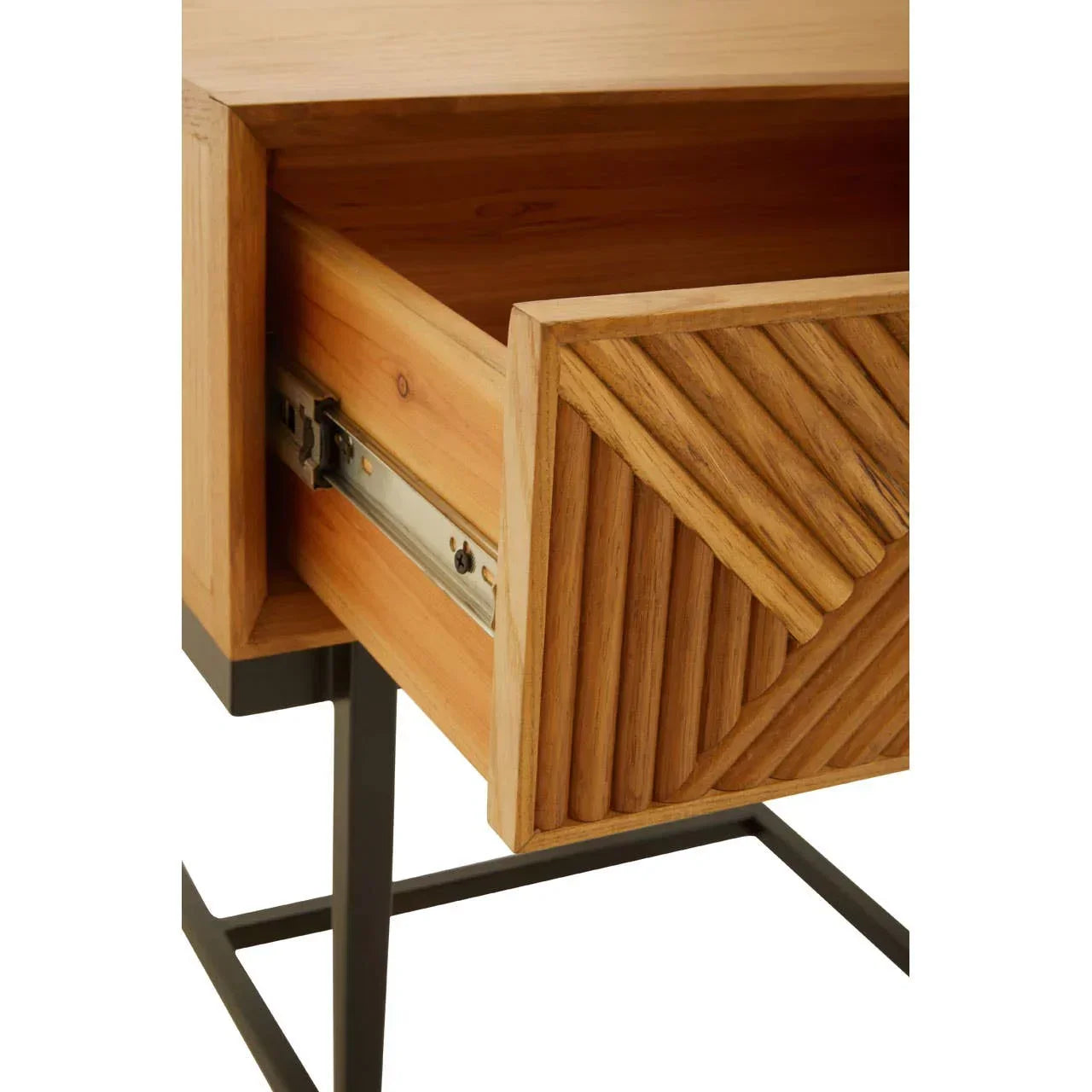 Close view of wooden side table drawer with carved geometric front and metal legs