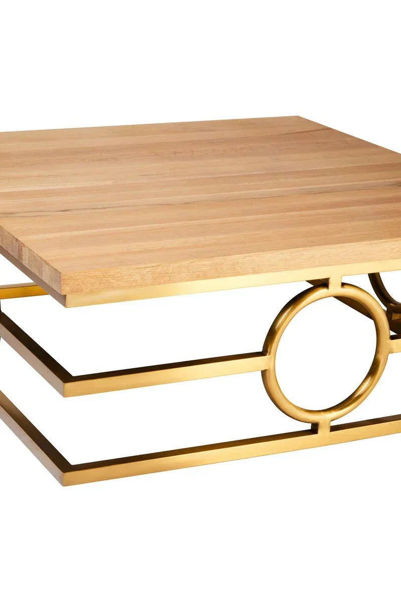 Square wooden coffee table with gold metal geometric base, close-up corner view