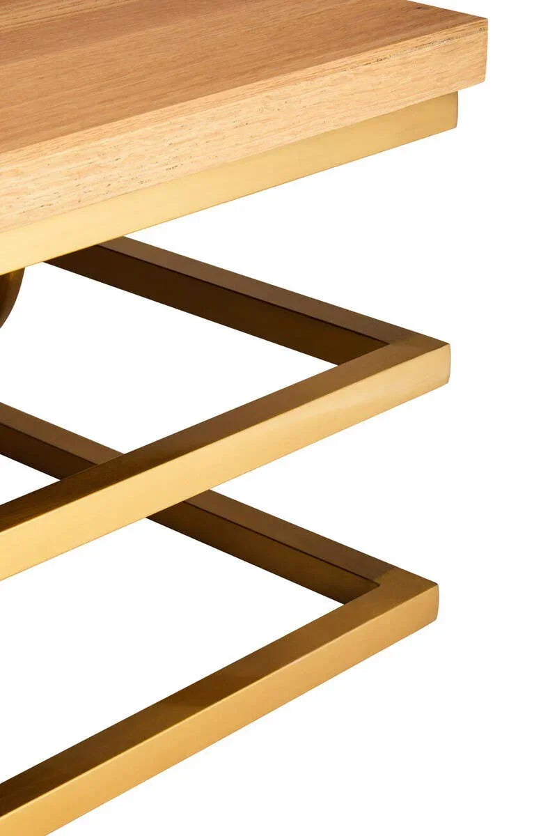 Close-up of coffee table with light oak wood top and gold square metal legs