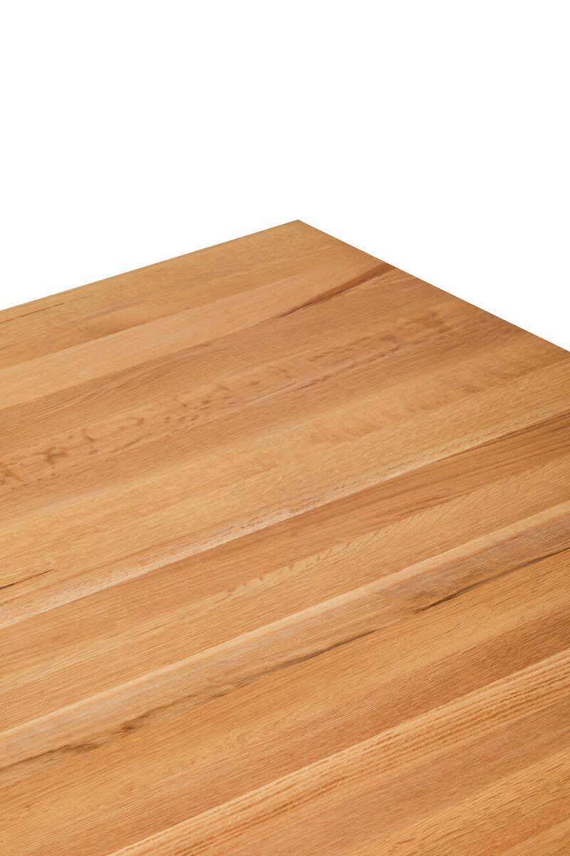 Close-up of oak dining table top with natural wood grain and smooth finish