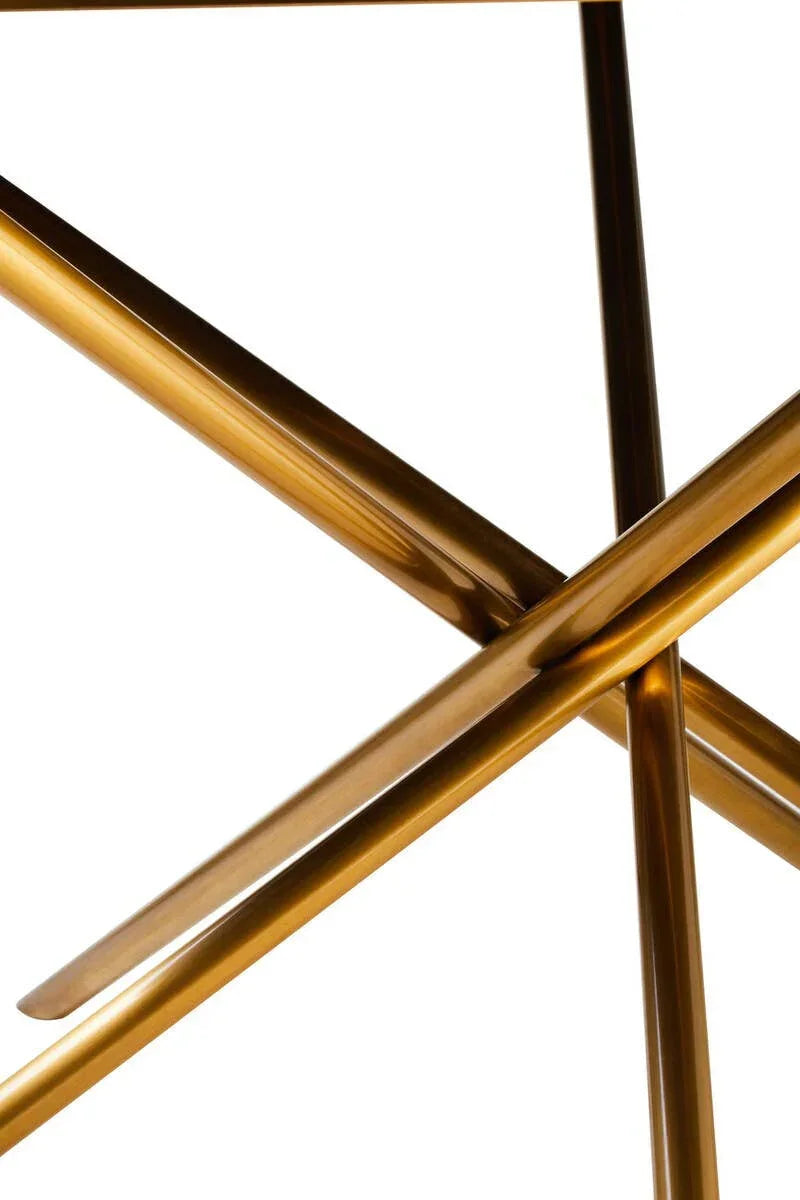 Close up of gold metal table legs with crossing geometric design