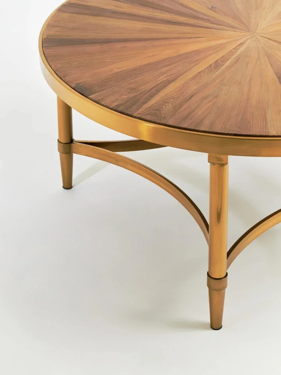 Round wooden coffee table with gold metal legs and sunburst veneer detail