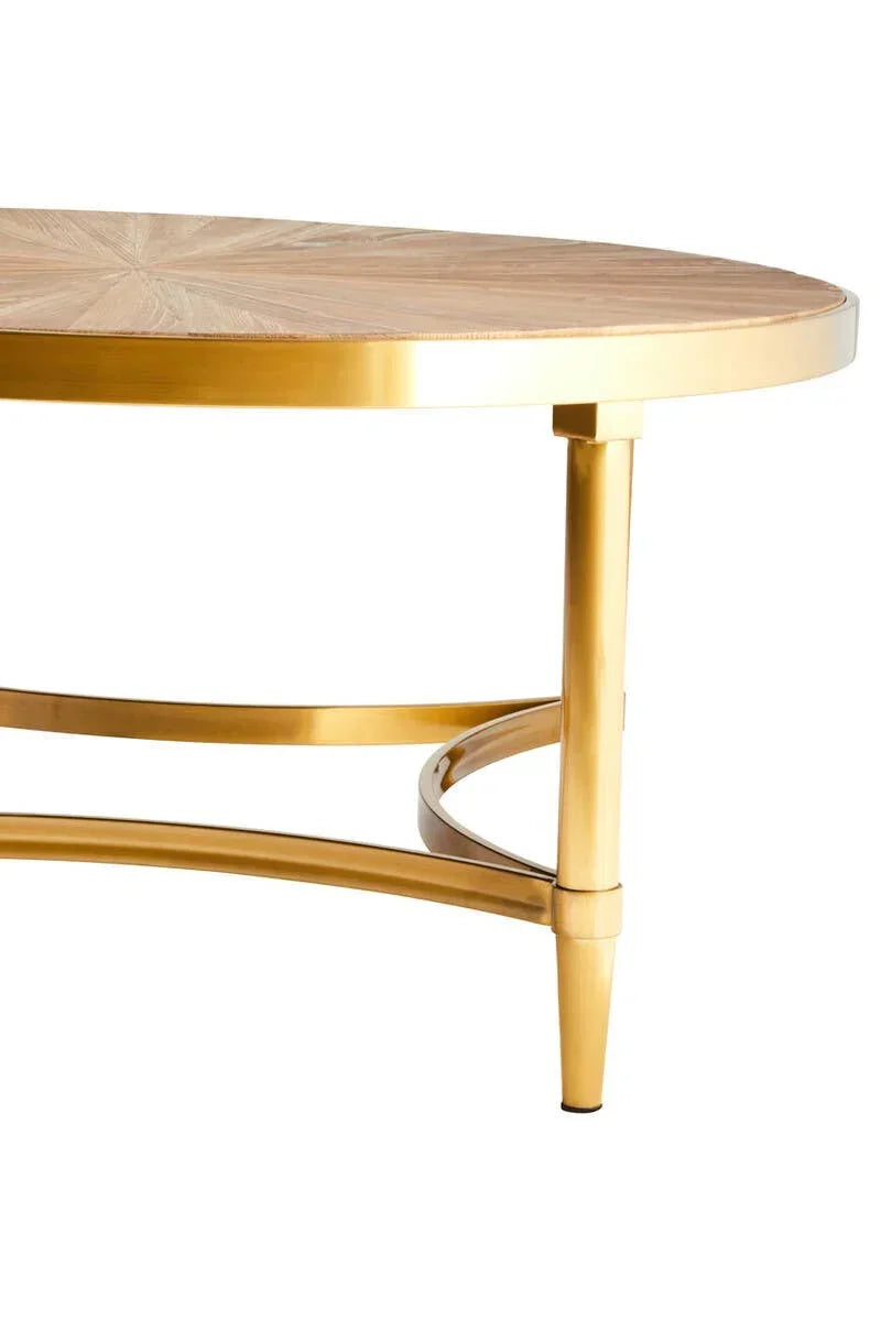 Round coffee table with light wood top and gold metal legs, close-up side view