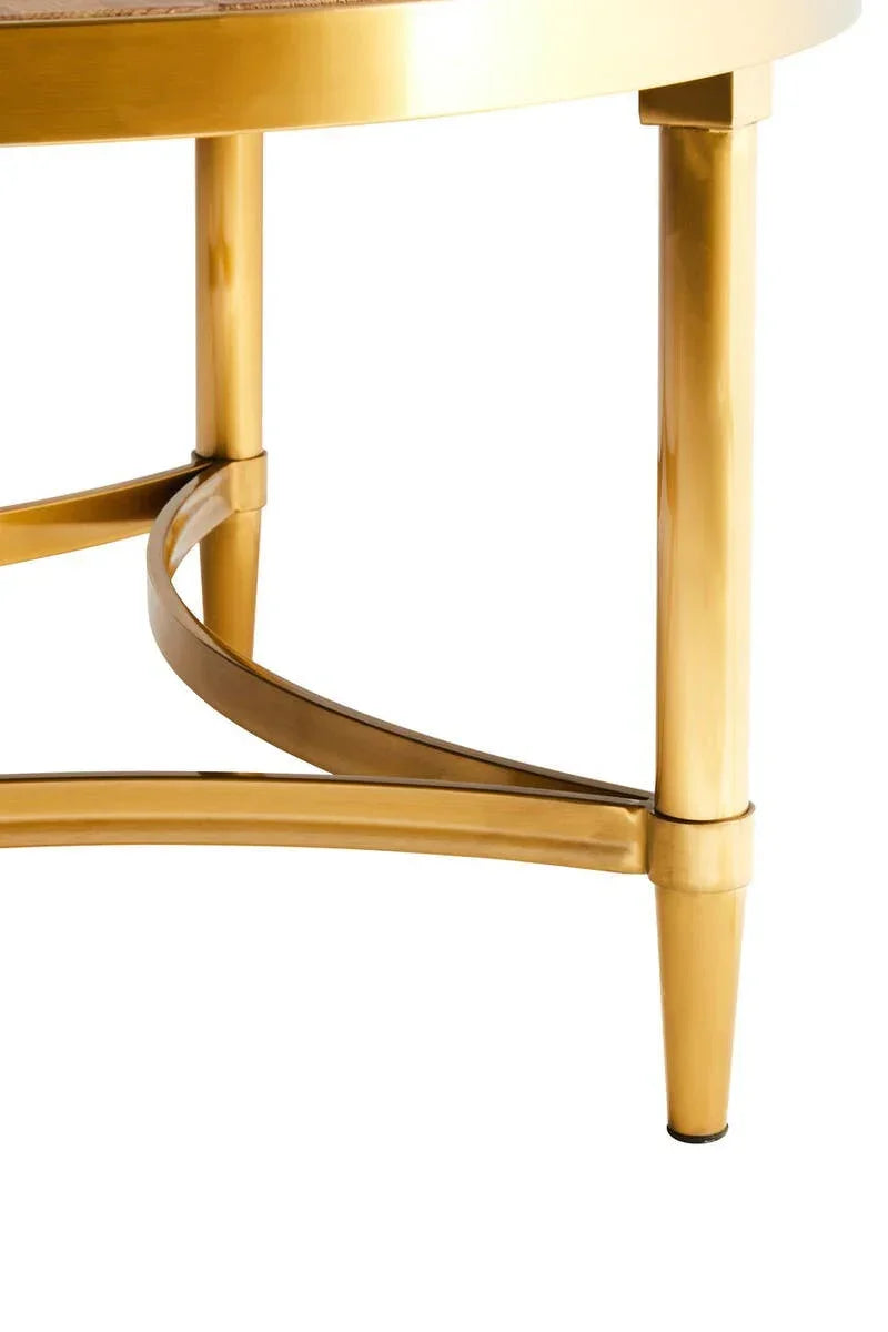 Gold metal coffee table legs with curved crossbar support, close-up view