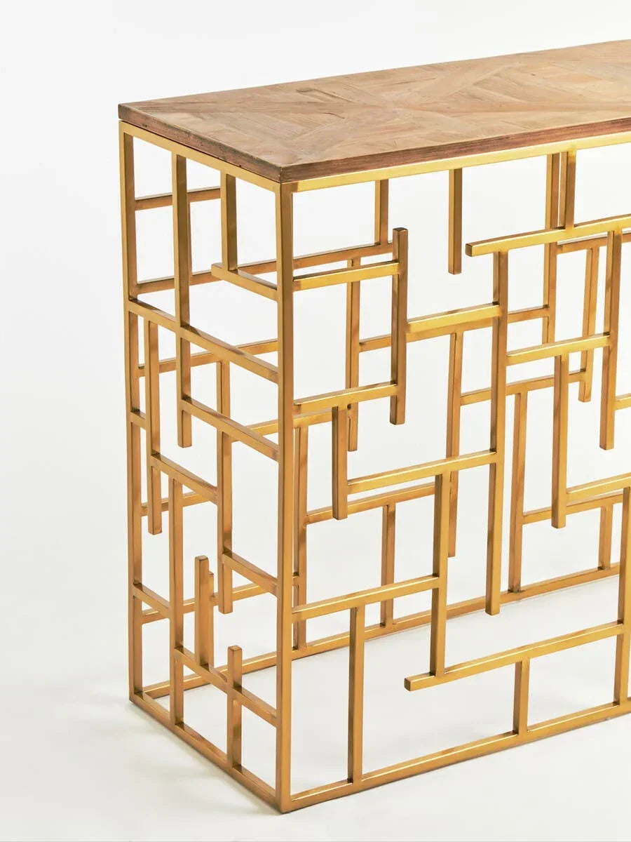 Gold metal console table with geometric frame and wood top, angled side view