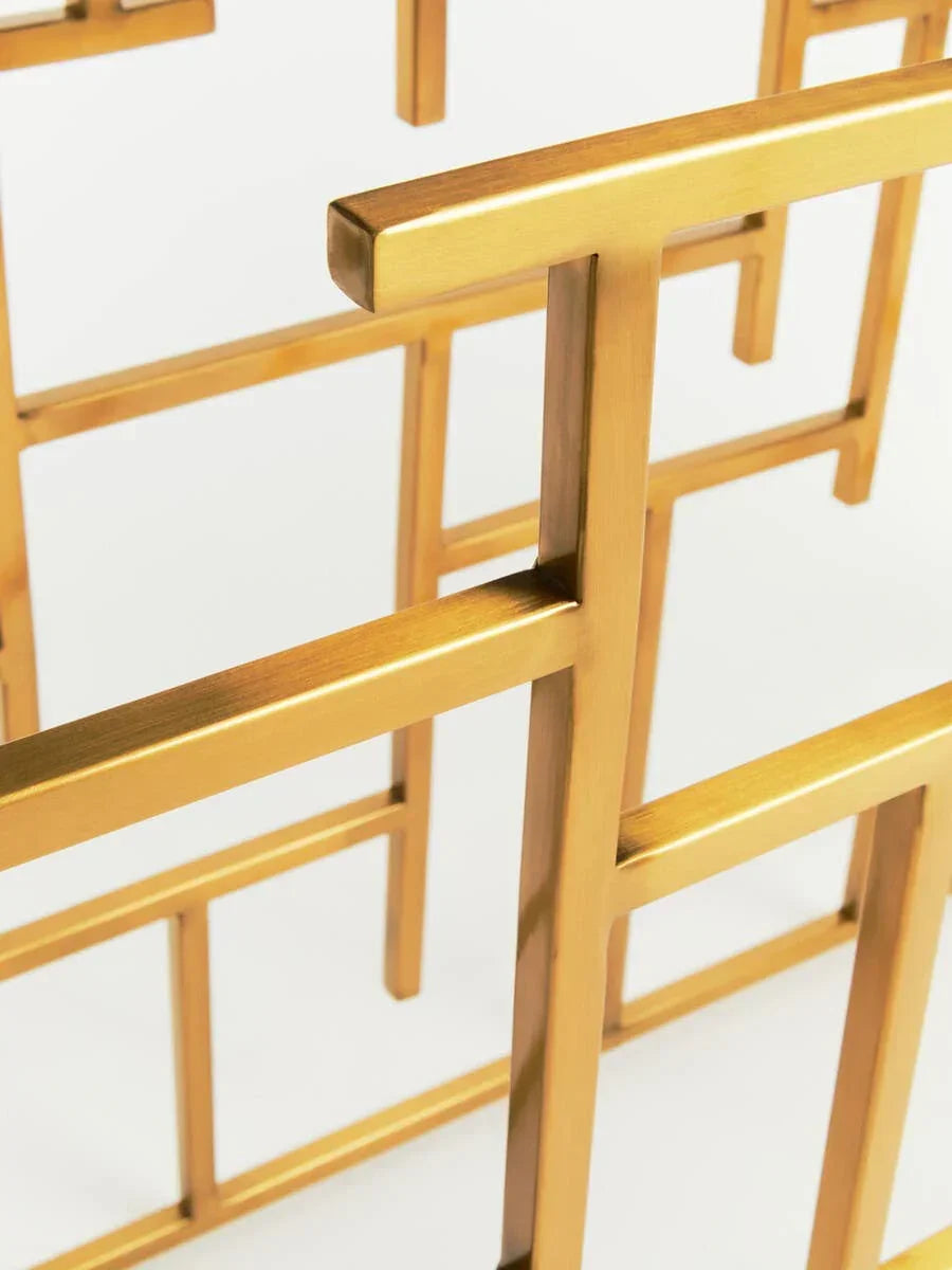Gold metal table frame with geometric design close-up