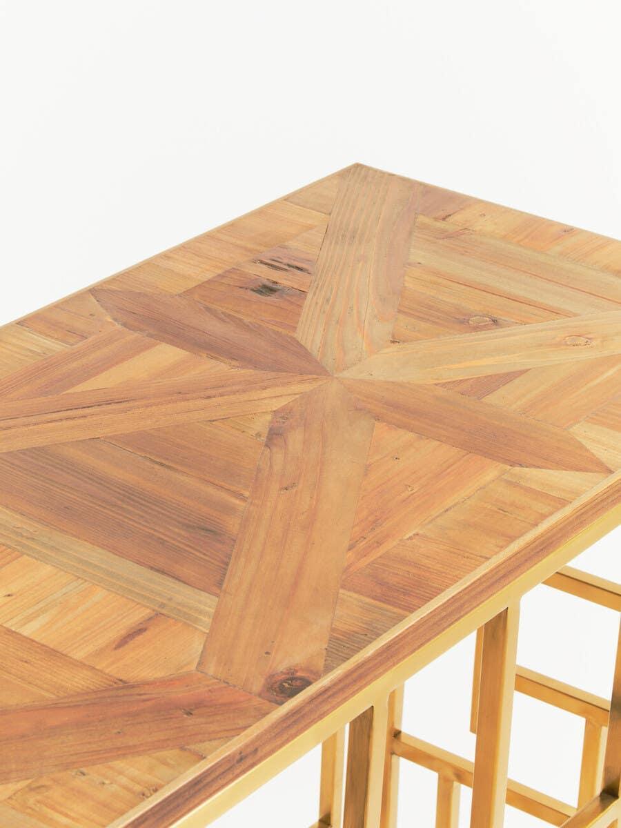 Wooden console table with geometric patterned tabletop and gold metal legs, corner view