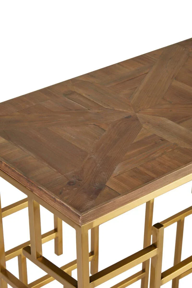 Wood console table with geometric pattern top and gold metal frame close-up