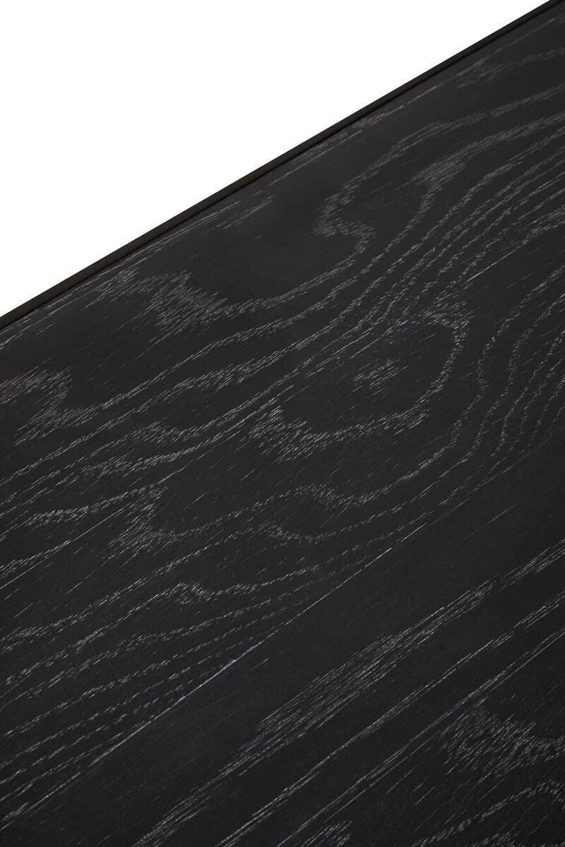 Black wood dining table surface with visible grain texture