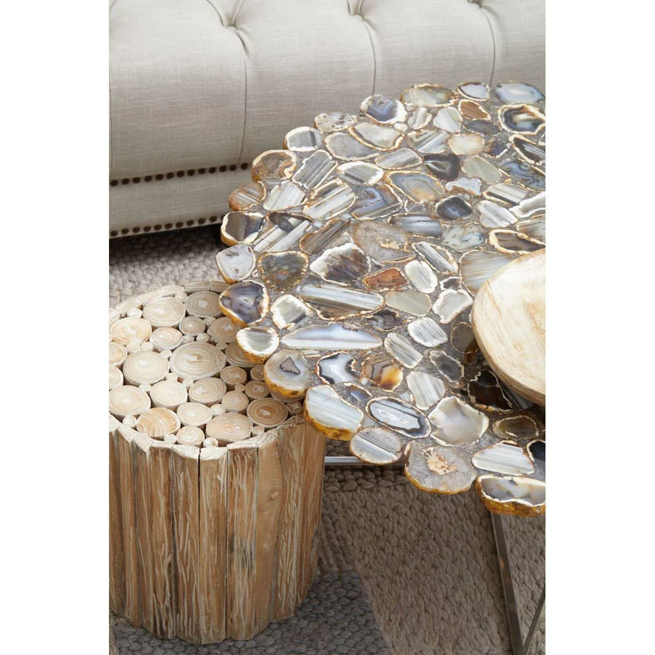 Agate stone top coffee table and wood log side table on textured rug