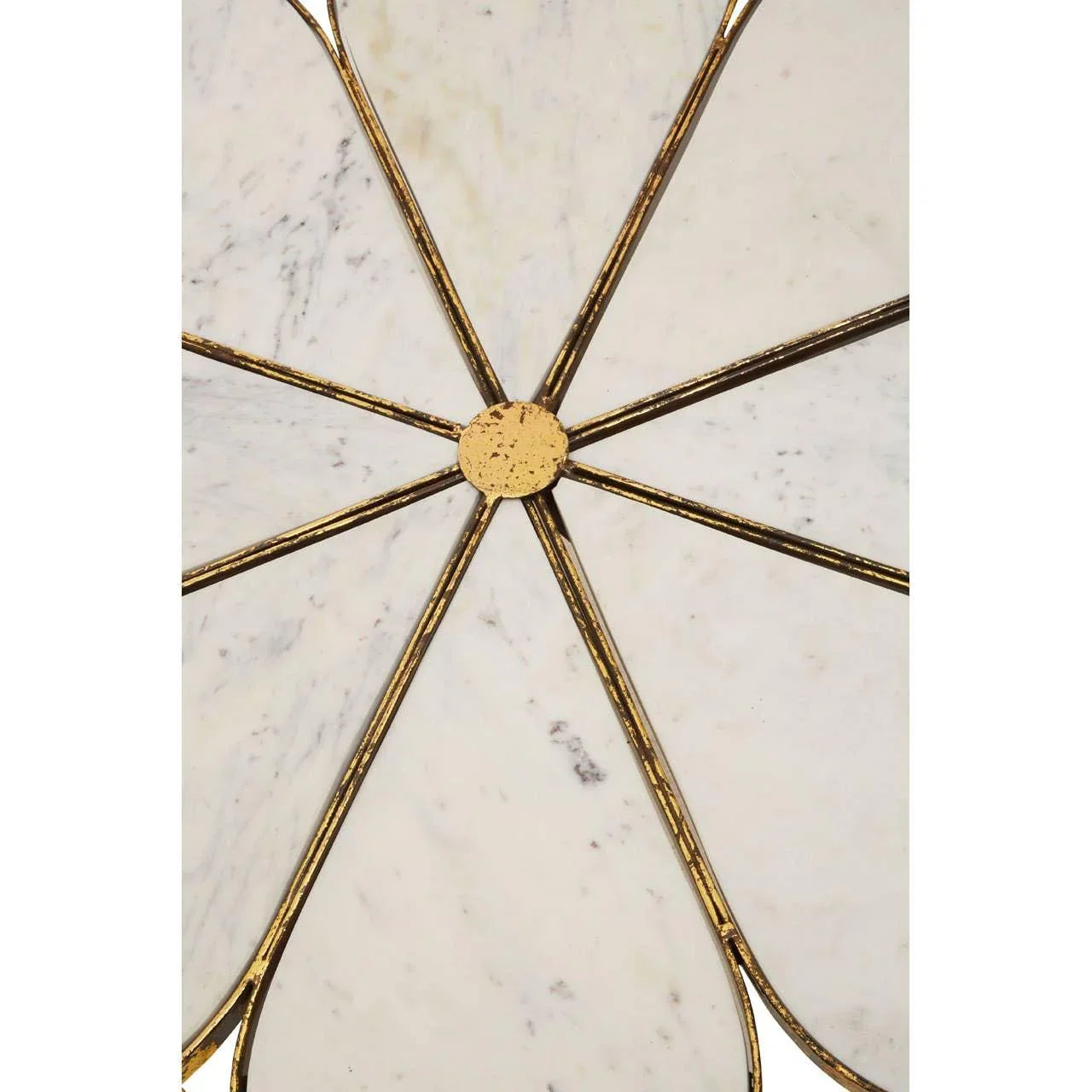Marble wall decor with gold metal spokes in a geometric petal design, close-up view