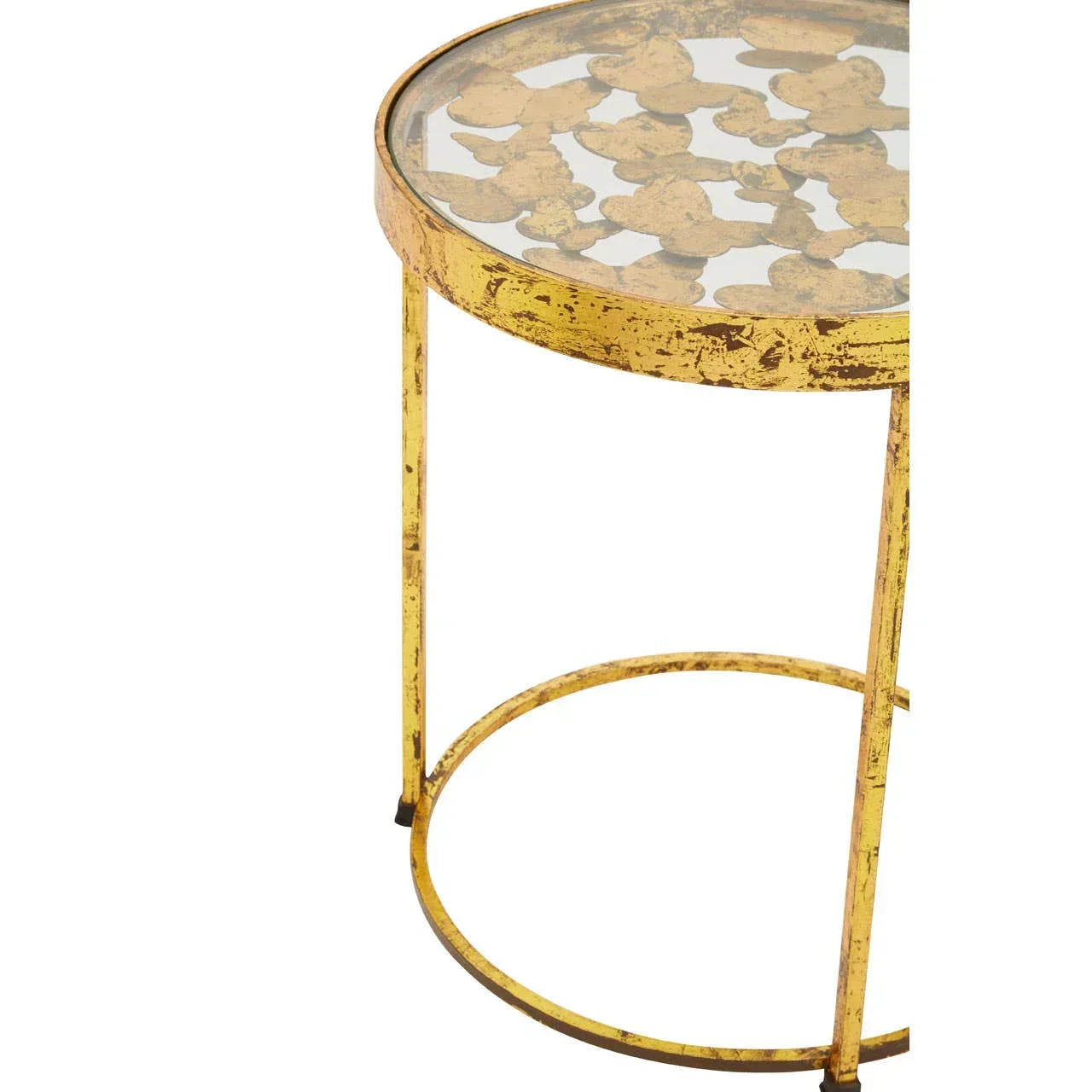 Round gold metal side table with glass top and decorative leaf accents