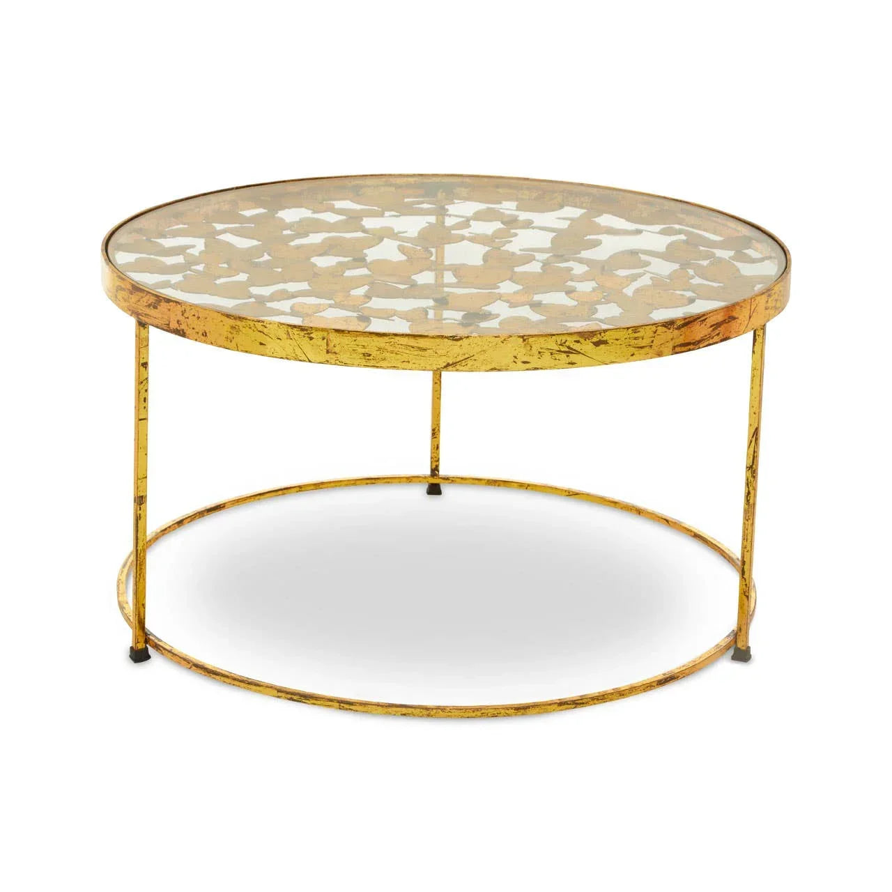 Round gold coffee table with glass top and leaf patterned metal base