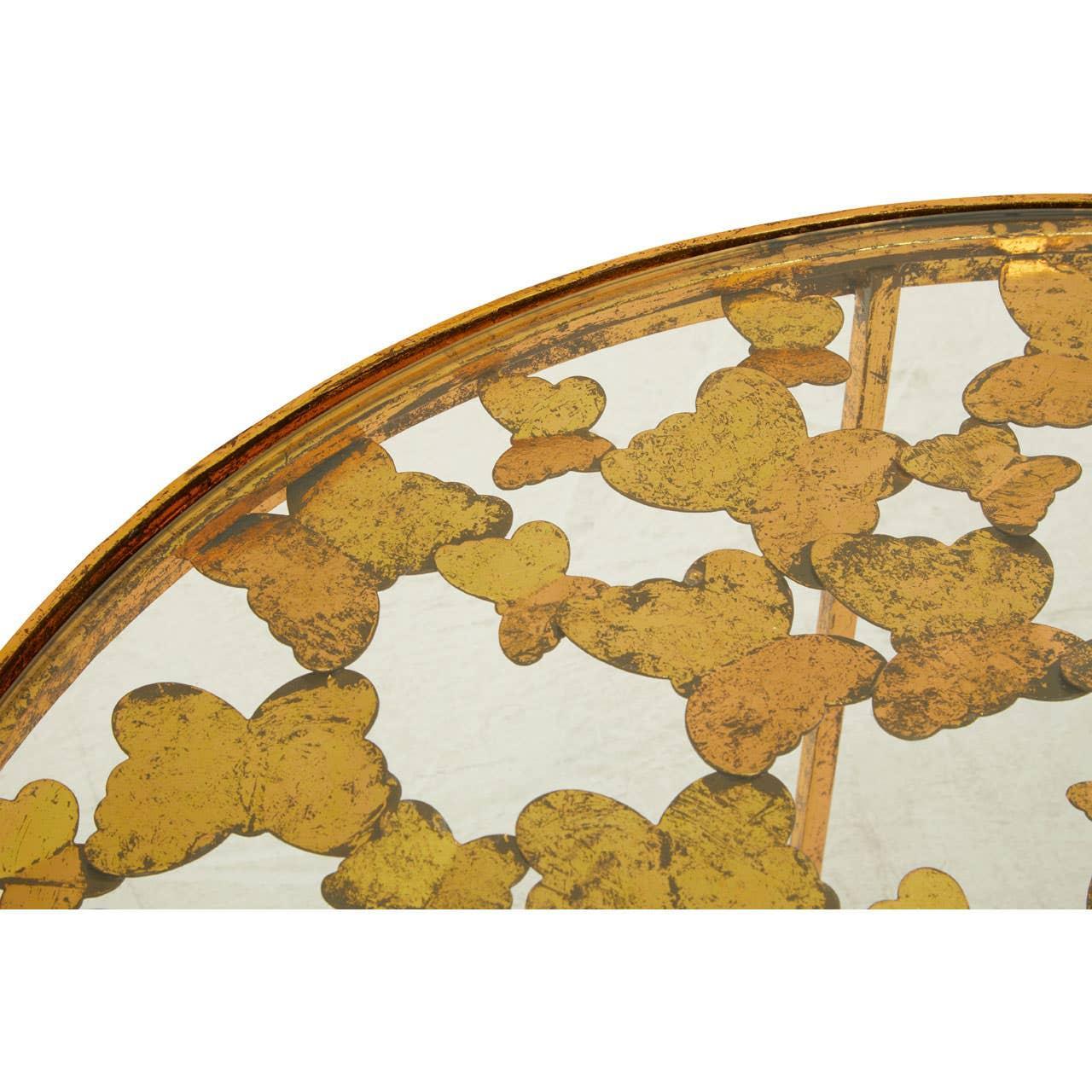 Glass coffee table with gold butterfly pattern closeup