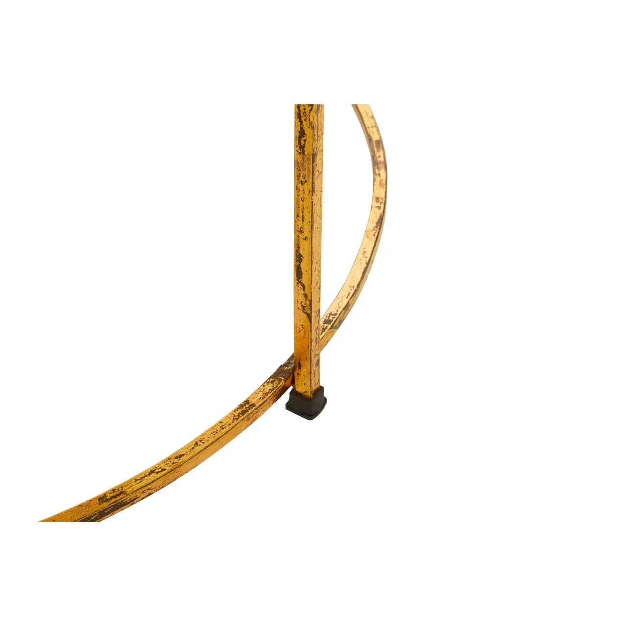 Close-up of gold metal table leg with curved support and black foot cap