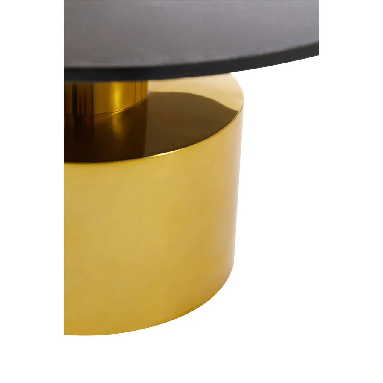 Close-up of gold metal coffee table base with matte black tabletop