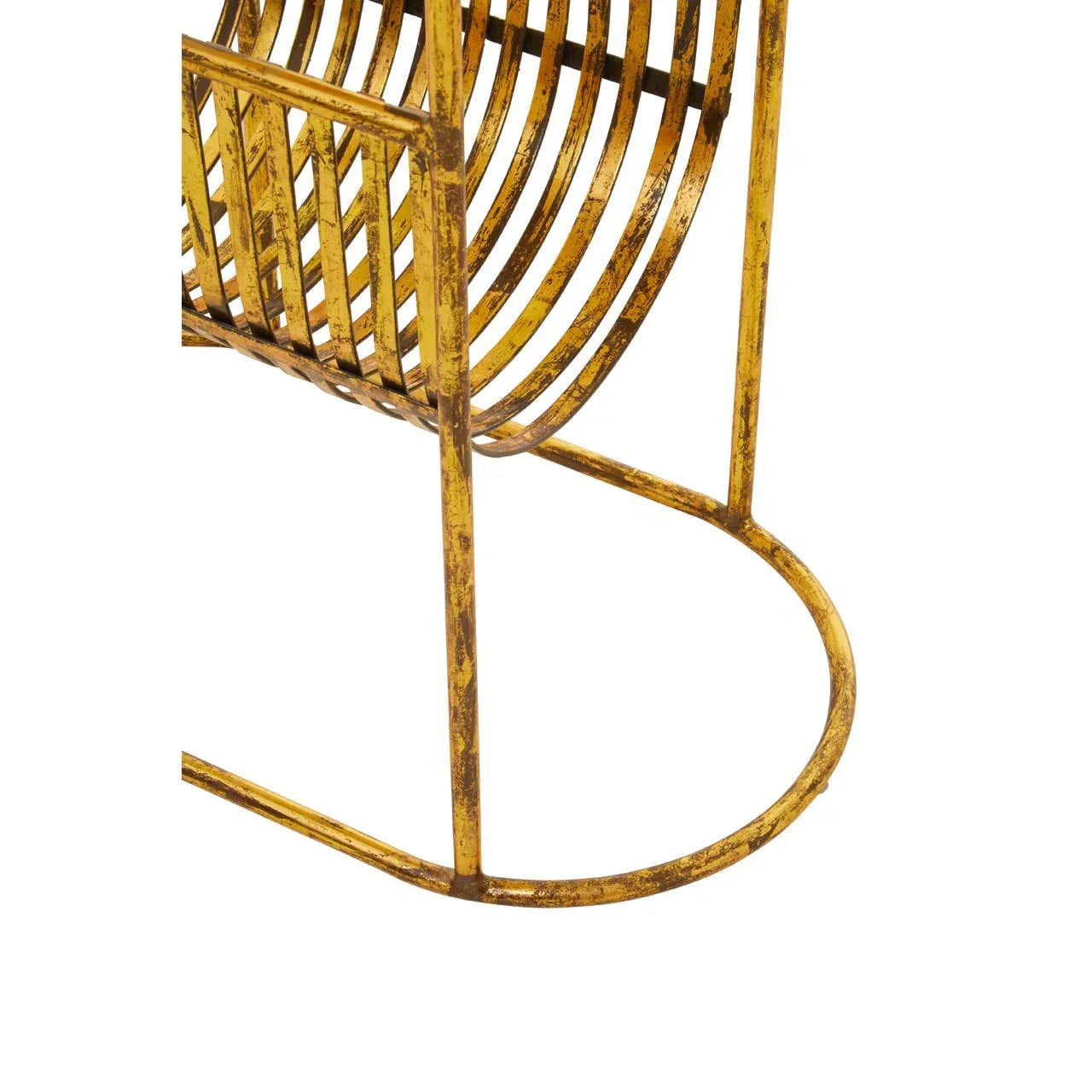 Gold metal magazine rack with curved frame and distressed finish, close-up view