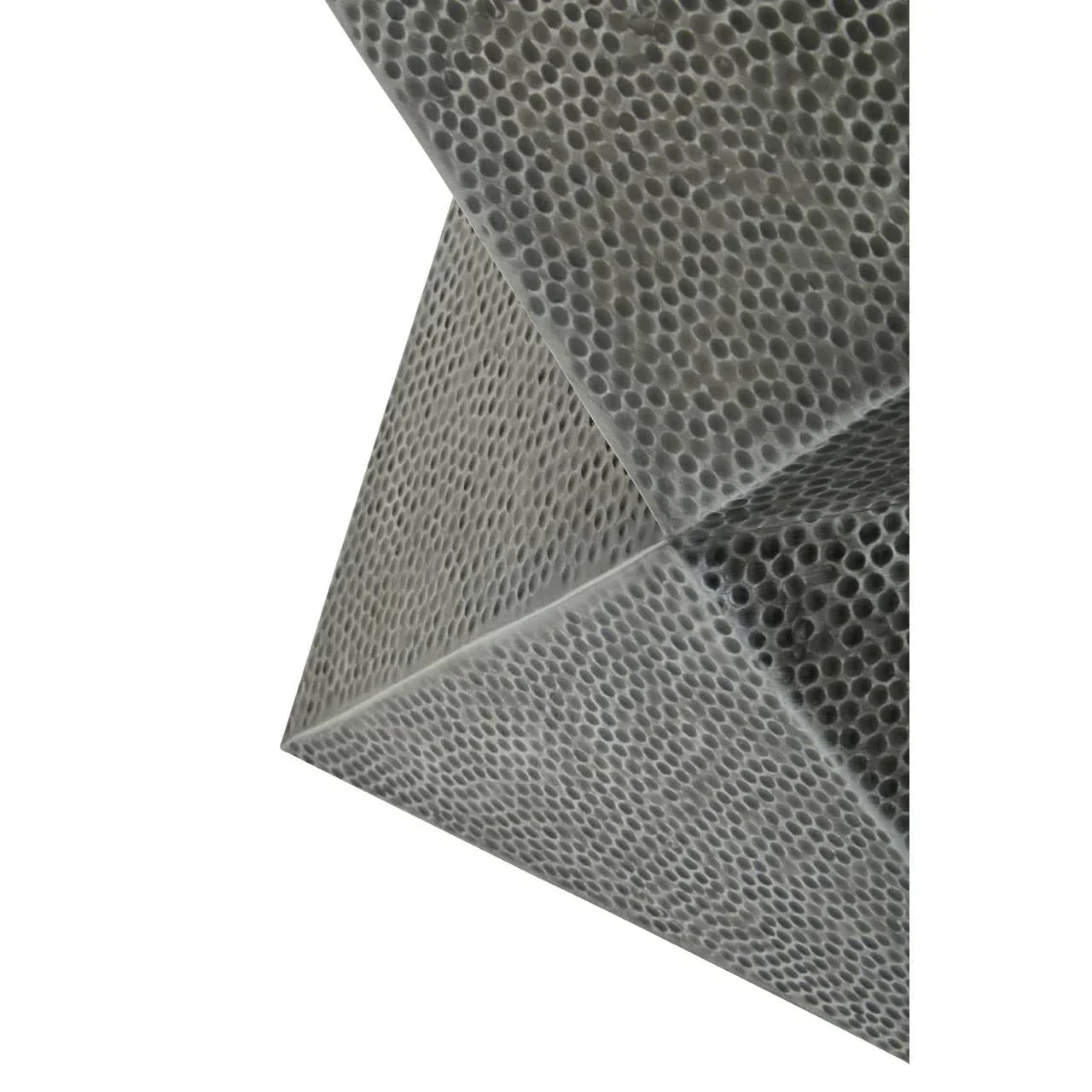 Close-up of hammered metal side table with geometric textured pattern