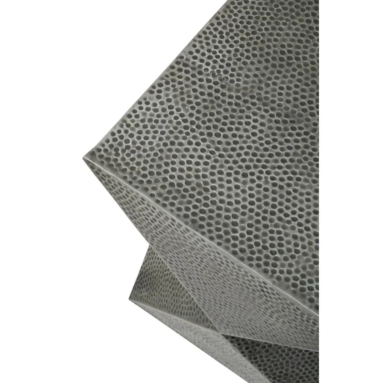 Close-up of textured metallic side table with geometric design