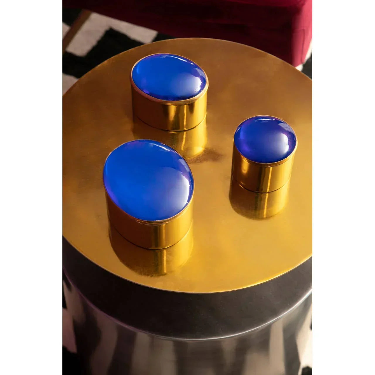 Gold metallic side table with three blue resin inlays on tabletop, contemporary furniture