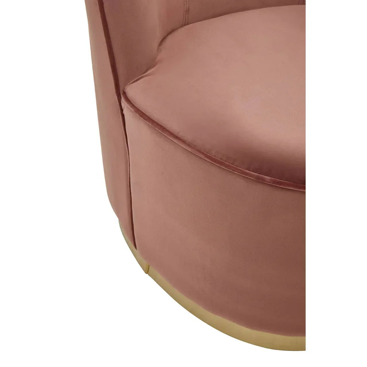 Close-up of blush pink velvet accent chair with gold metal base