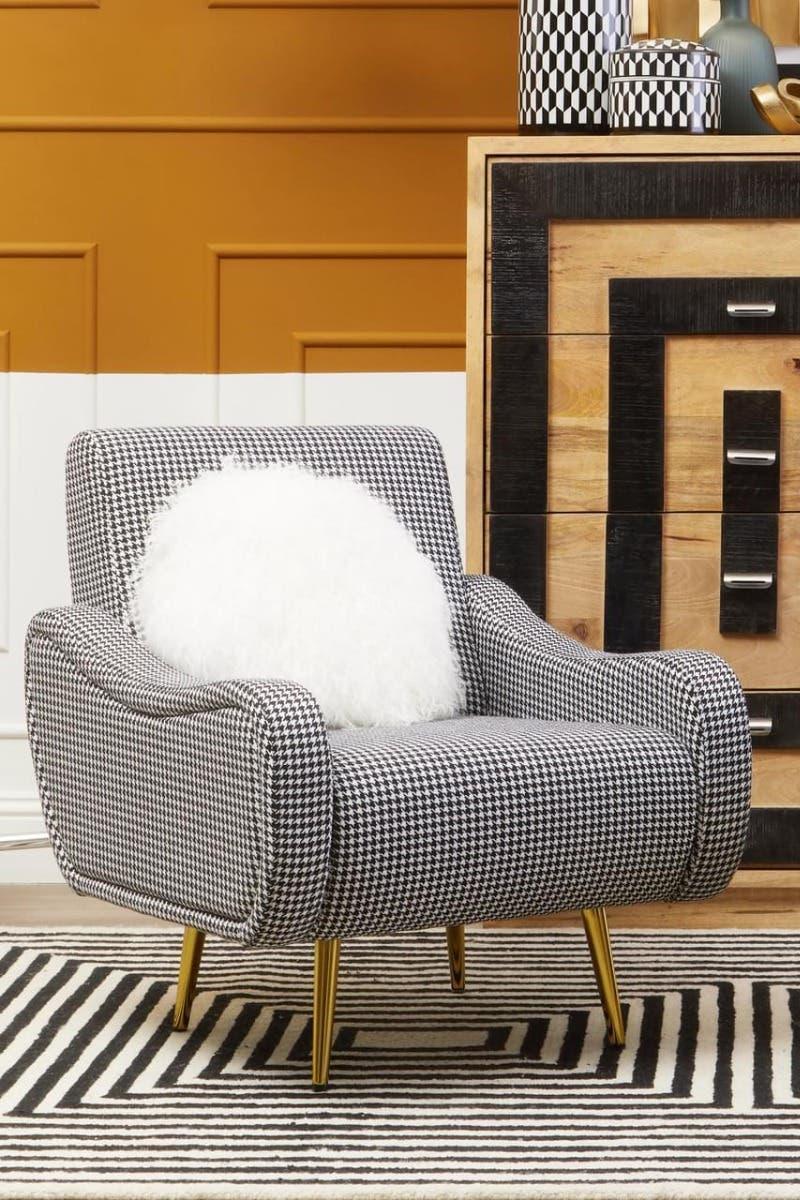 Houndstooth accent chair with gold legs and white cushion in modern living room