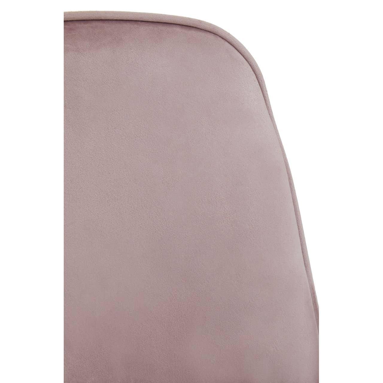 Closeup of pink velvet chair backrest with rounded edge detail