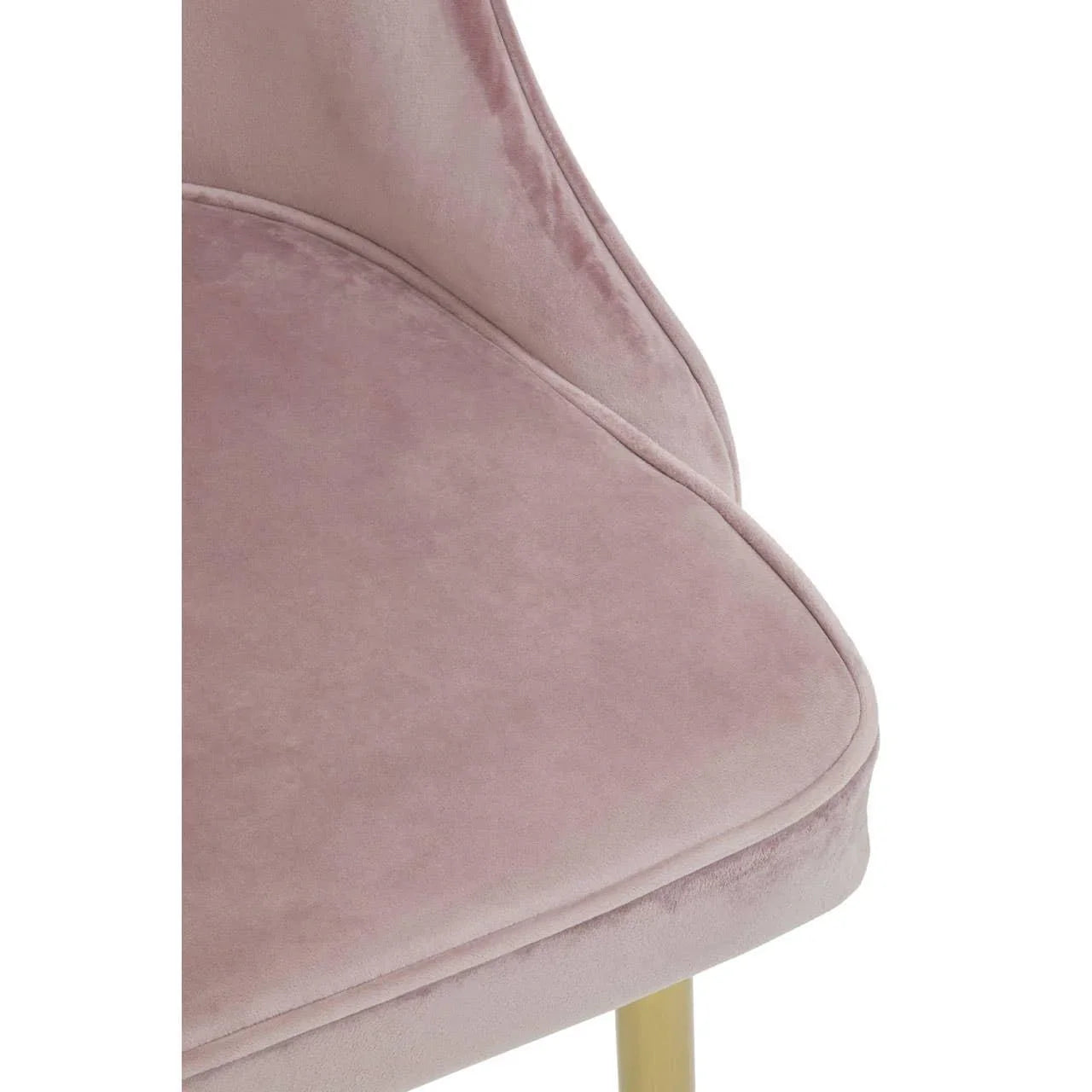 Blush pink velvet dining chair seat with gold metal leg detail, close-up view