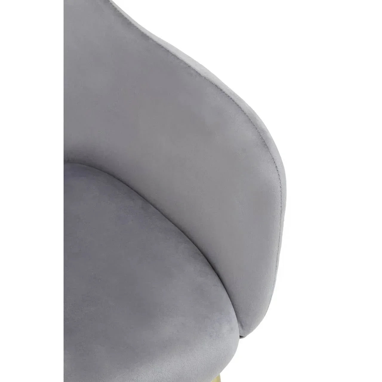 Close-up of grey velvet dining chair upholstery with curved backrest