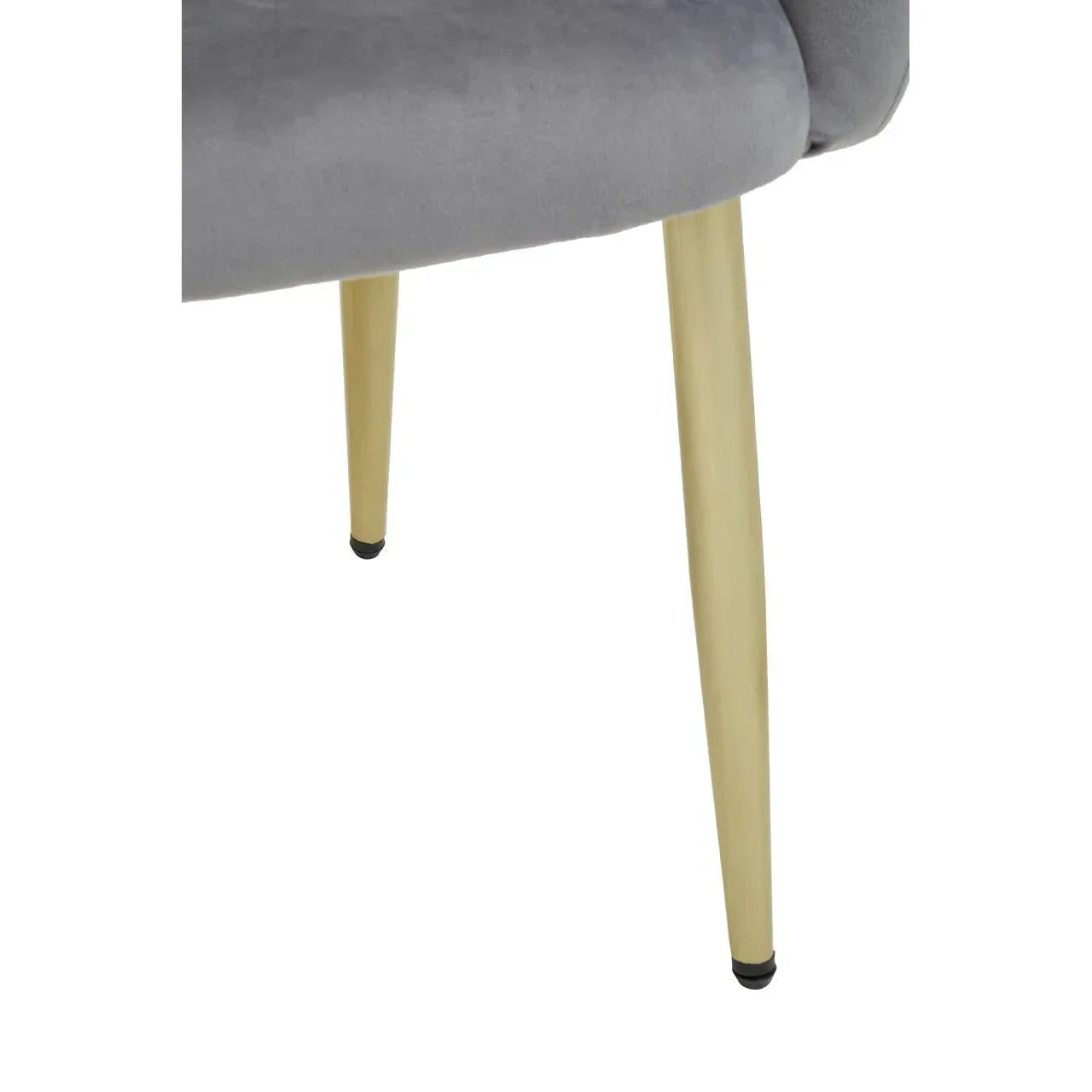 Close view of grey velvet chair seat with tapered gold metal legs