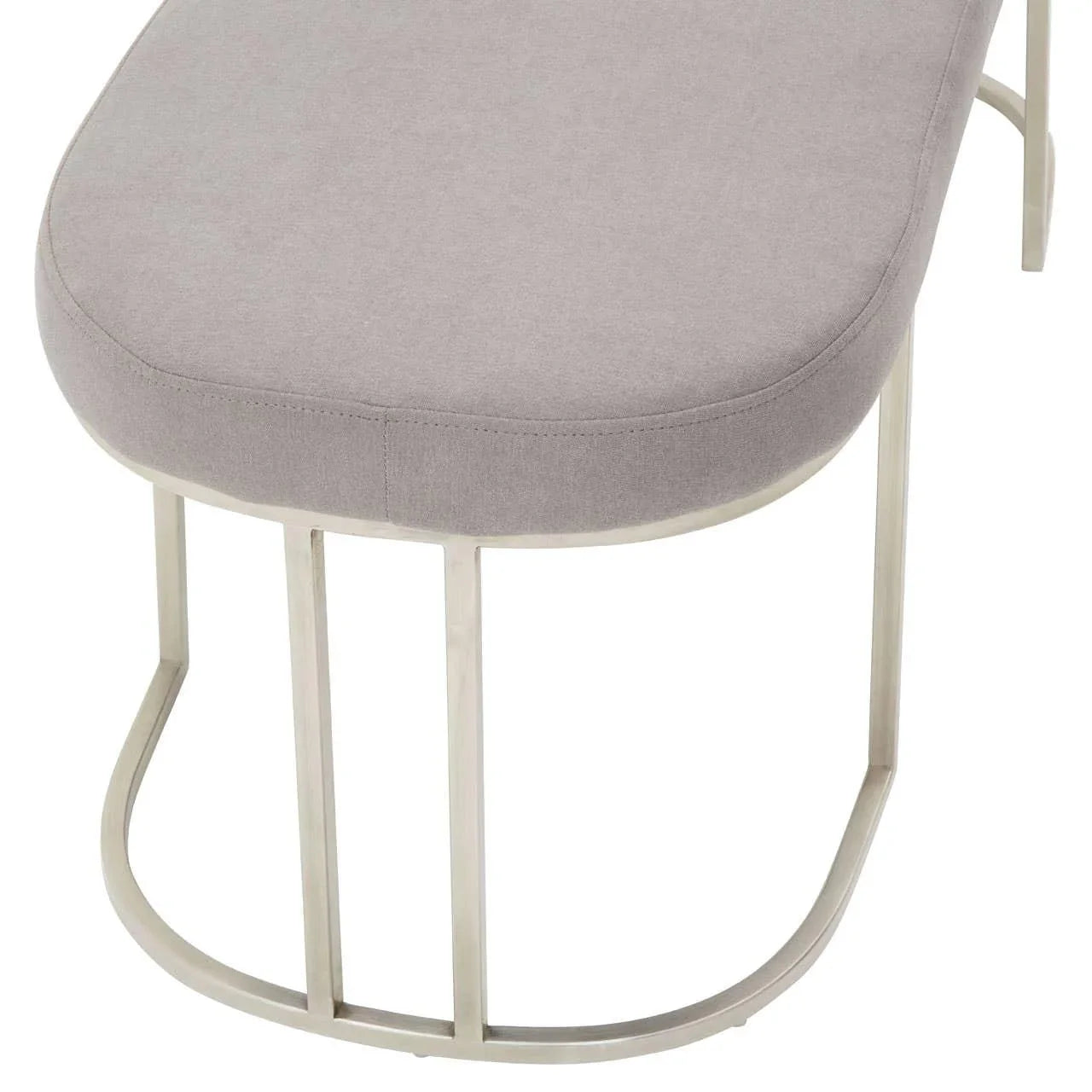Grey upholstered bench seat with curved metal base, close-up on fabric and leg design